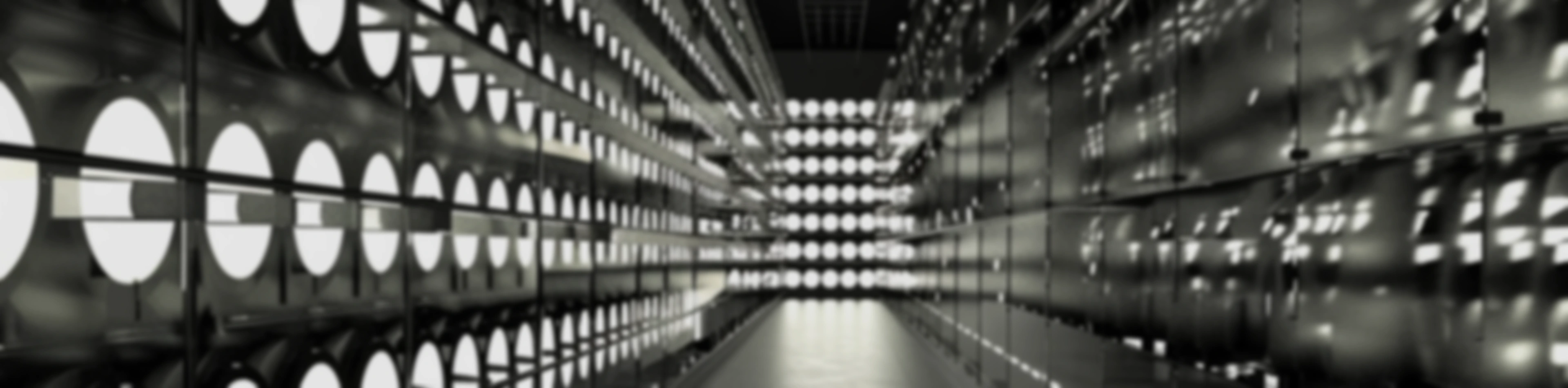 Rows of illuminated mining machines lining a data-centre aisle